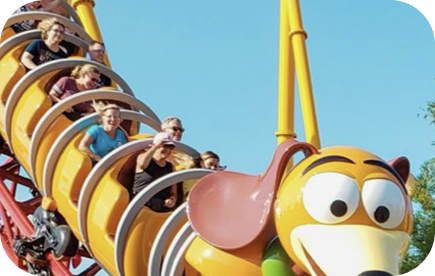 Family roller coaster ascending a bright red track