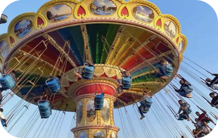 Rainbow swing carousel against a blue sky